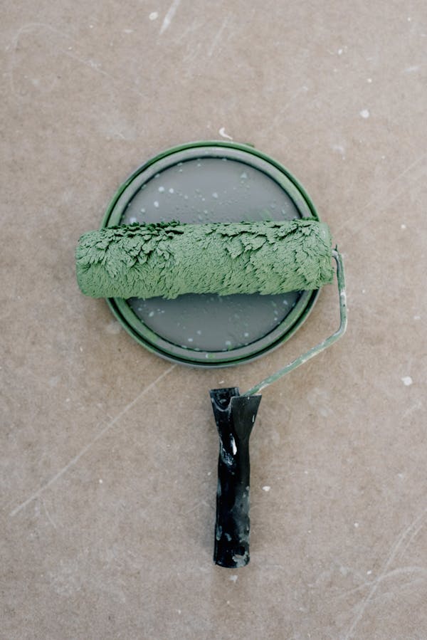 Green paint roller on paint can
